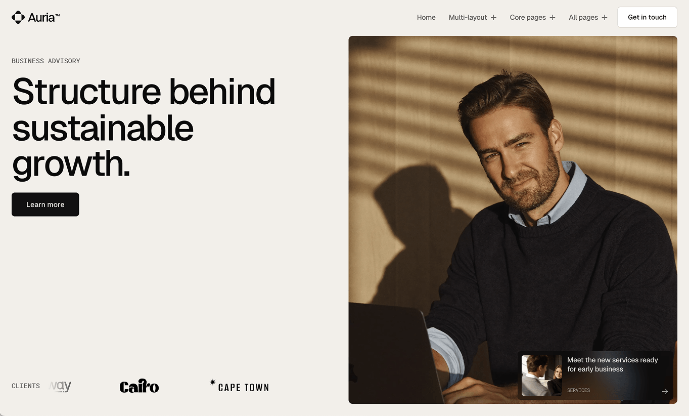 Business advisory site with a man in a navy sweater near a laptop and text about sustainable growth.